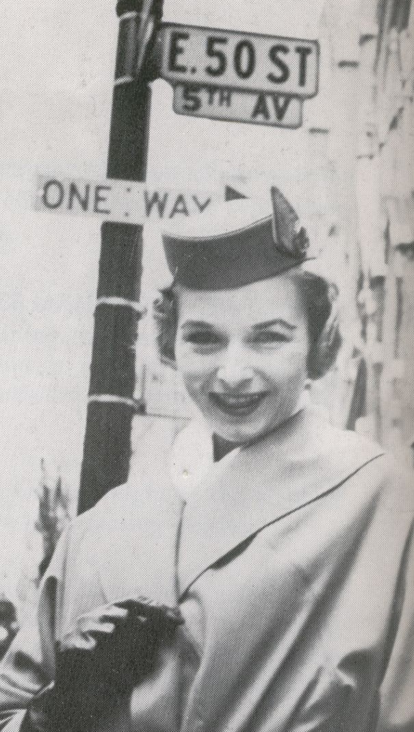 1959 A Pan Am stewardess at the corner of 5th Avenue & 50th Street in New York City.